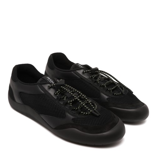 Prada Black Speedrock Sneakers. Black low-top sneakers with a sleek, contemporary sporty silhouette.