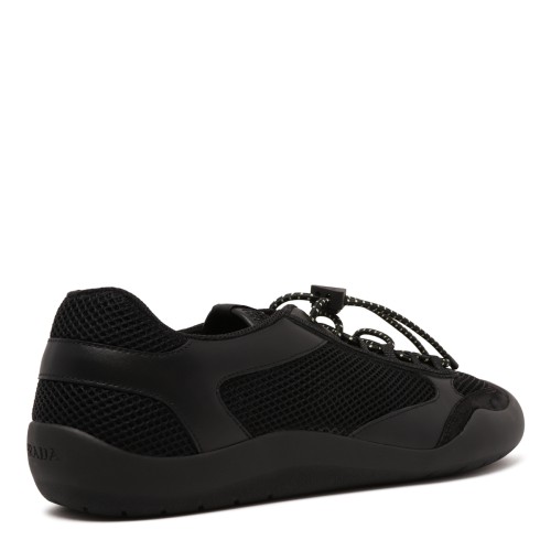 Prada Black Speedrock Sneakers. Black low-top sneakers with a sleek, contemporary sporty silhouette.
