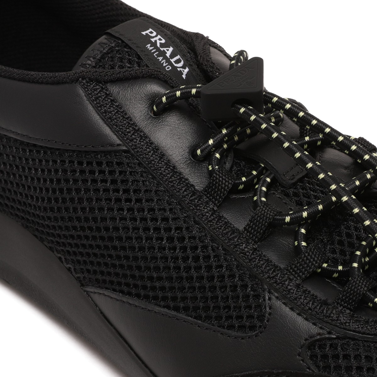Prada Black Speedrock Sneakers. Black low-top sneakers with a sleek, contemporary sporty silhouette.