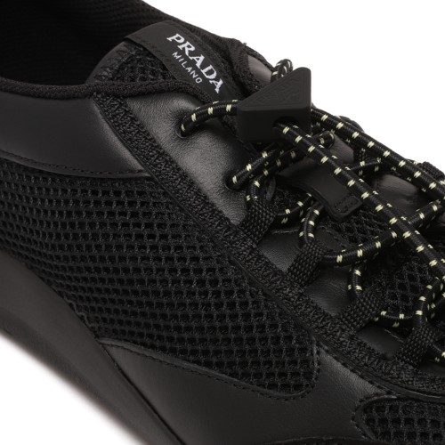 Prada Black Speedrock Sneakers. Black low-top sneakers with a sleek, contemporary sporty silhouette.